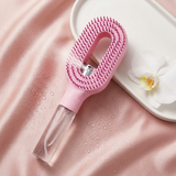 The Mist Ritual Brush flatlay on blush silk with white orchid